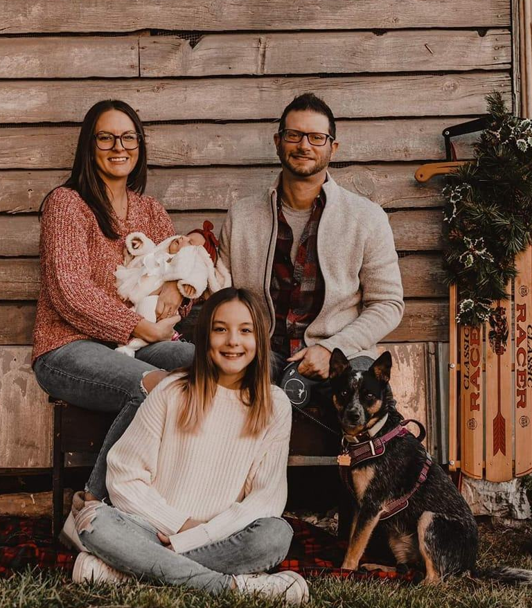 Smiling electrician with his family and dog, showcasing trust and family values behind the brand in electrical service marketing.